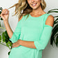 Plus size cold shoulder top in green with cut-out shoulders