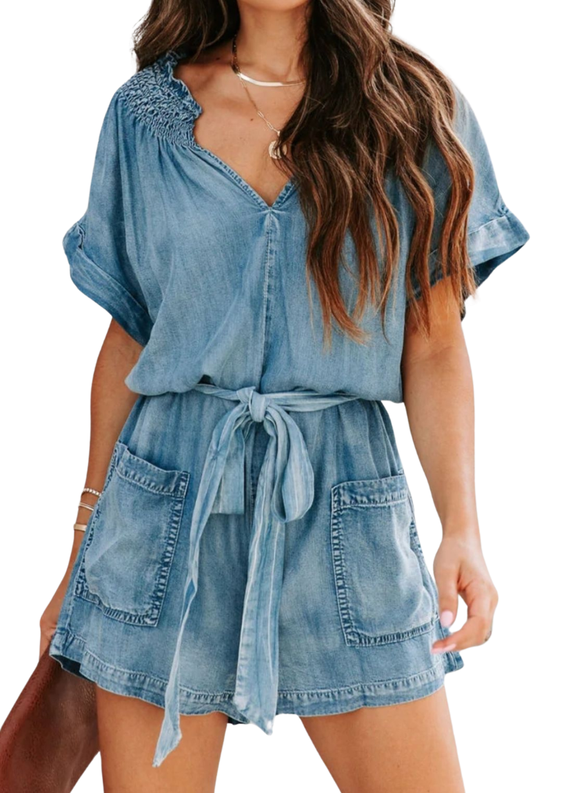 Chic denim romper with notched neckline and adjustable tie waist for a perfect fit. Versatile, comfortable, and perfect for summer days.