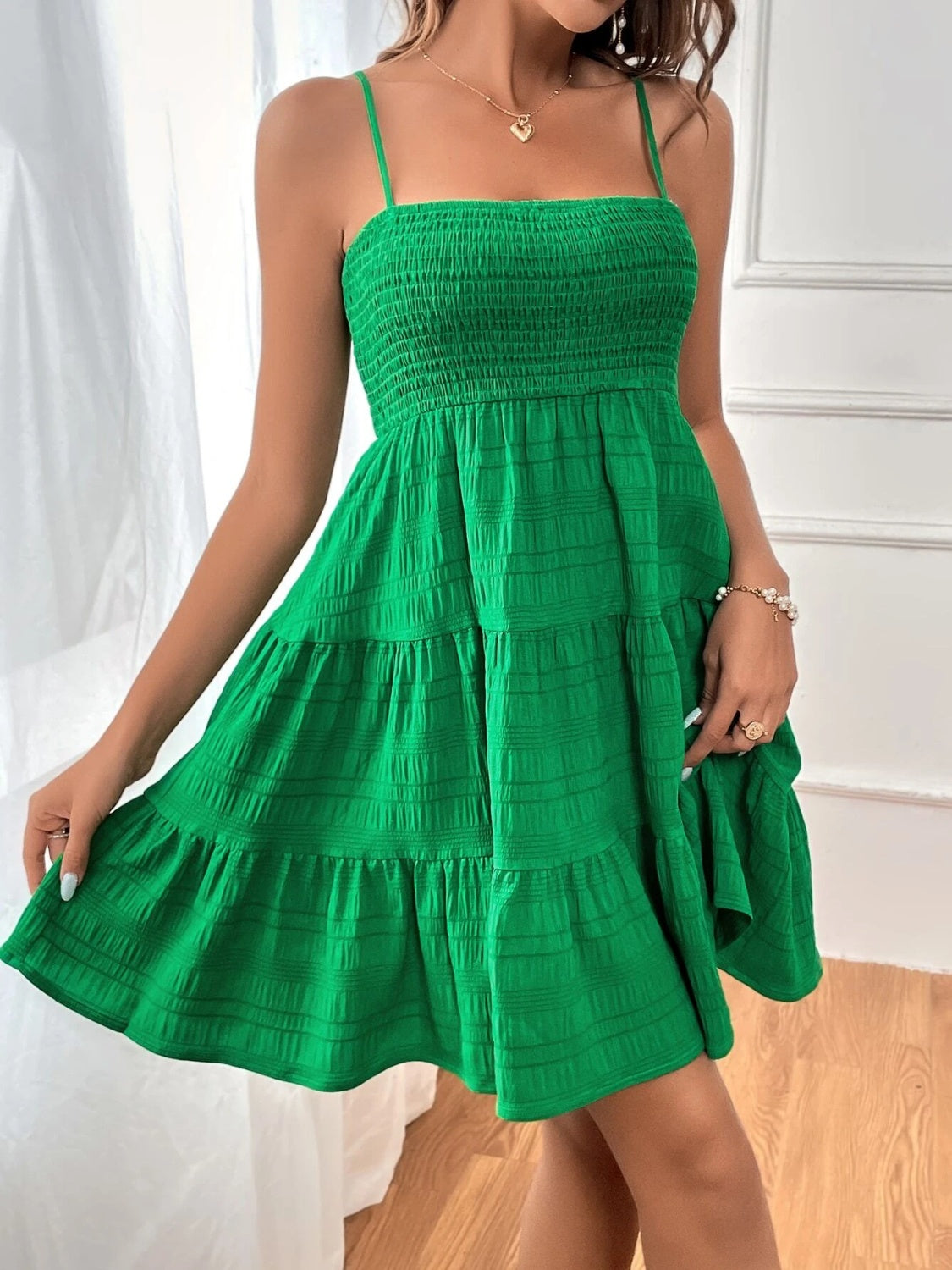 Chic sleeveless smocked green dress with tiered skirt, perfect for summer. Available in 8 colors. Get yours today!