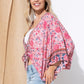 Flowy kimono in pink with floral details.