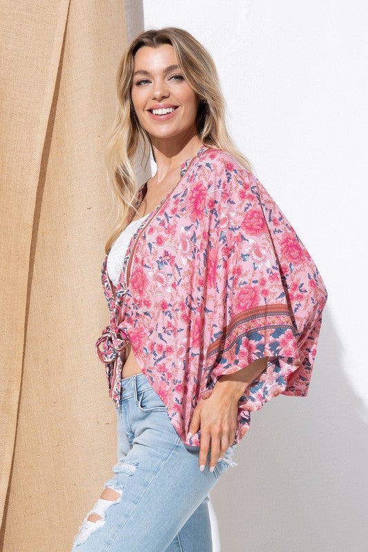 Flowy kimono in pink with floral details.