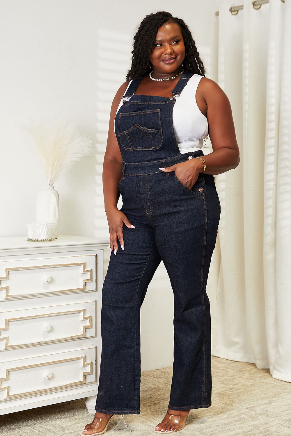 Women's dark blue denim overalls with a straight leg design