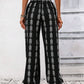 Black drawstring pants featuring a stylish bohemian print