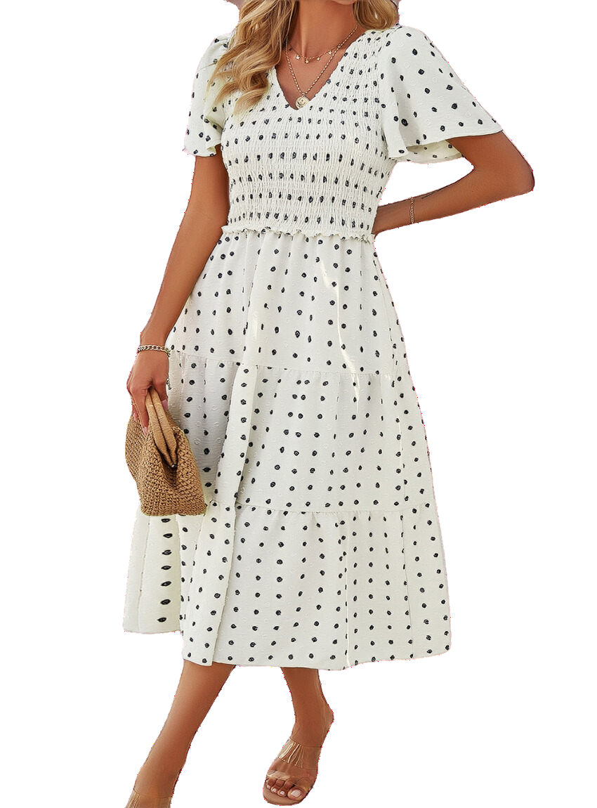 Swiss Dot Dress with a flattering smocked design, available in black, cream, moss, and blue. Perfect for any summer occasion