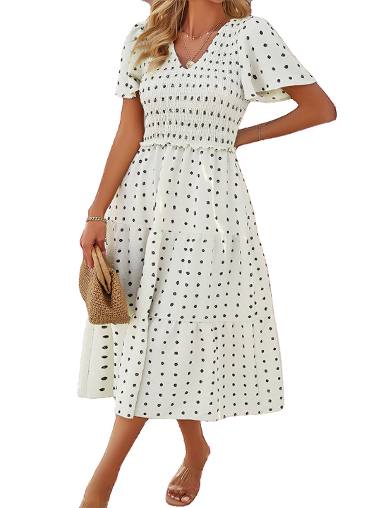 Swiss Dot Dress with a flattering smocked design, available in black, cream, moss, and blue. Perfect for any summer occasion