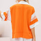 Orange pullover featuring bold white stripe accents