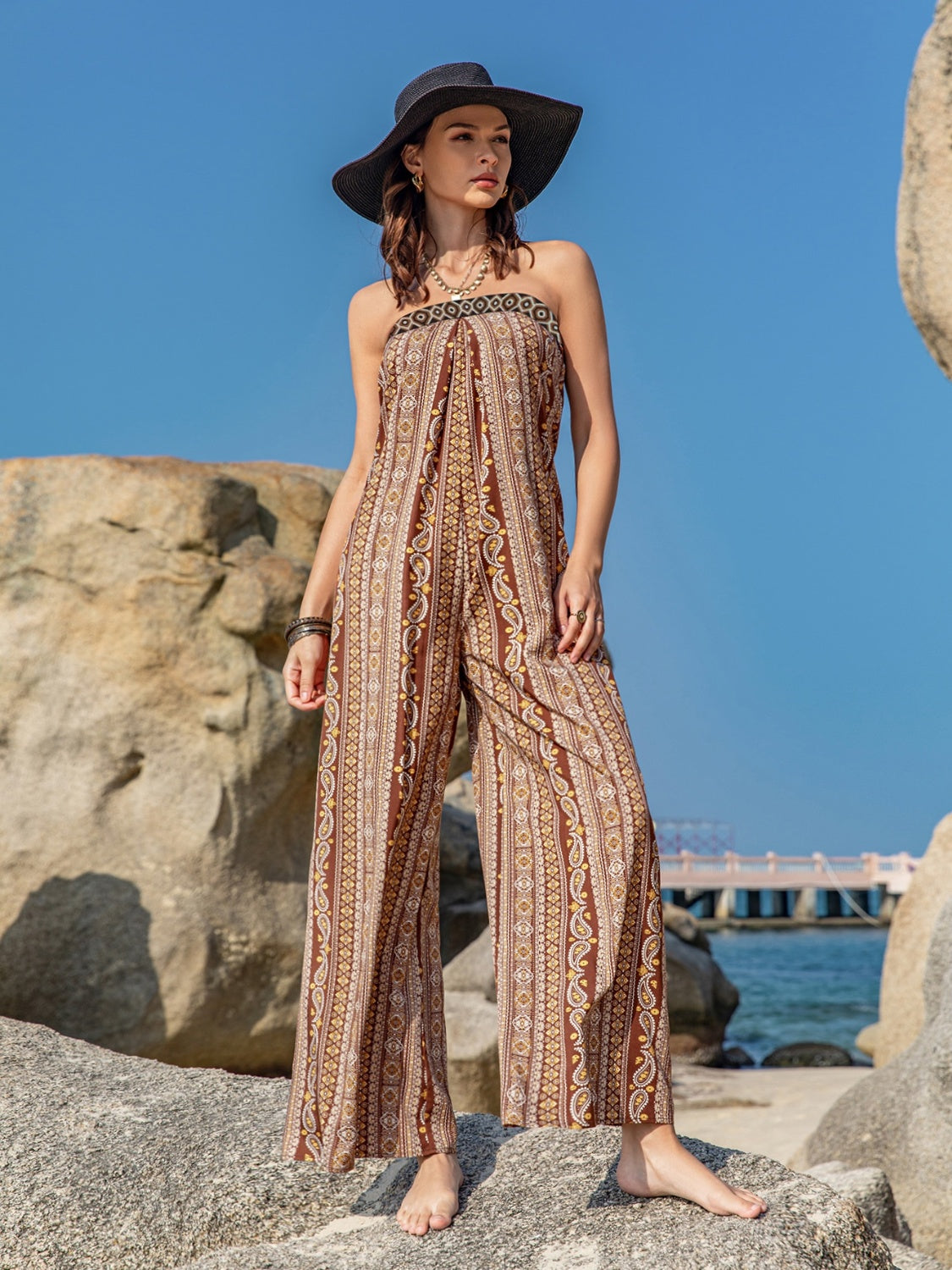 Embrace summer with our Printed Tube Wide Leg Jumpsuit. Perfect for any occasion, available in lilac, black, and camel. Shop now for effortless style!