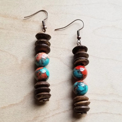 Unique handcrafted earrings featuring vibrant turquoise and coral beads, accented with rustic wooden discs, showcasing a bohemian and earthy design.