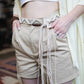 Beige macramé belt with wooden beads and braided tassels.