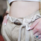High-quality macramé belt with bohemian design in beige.