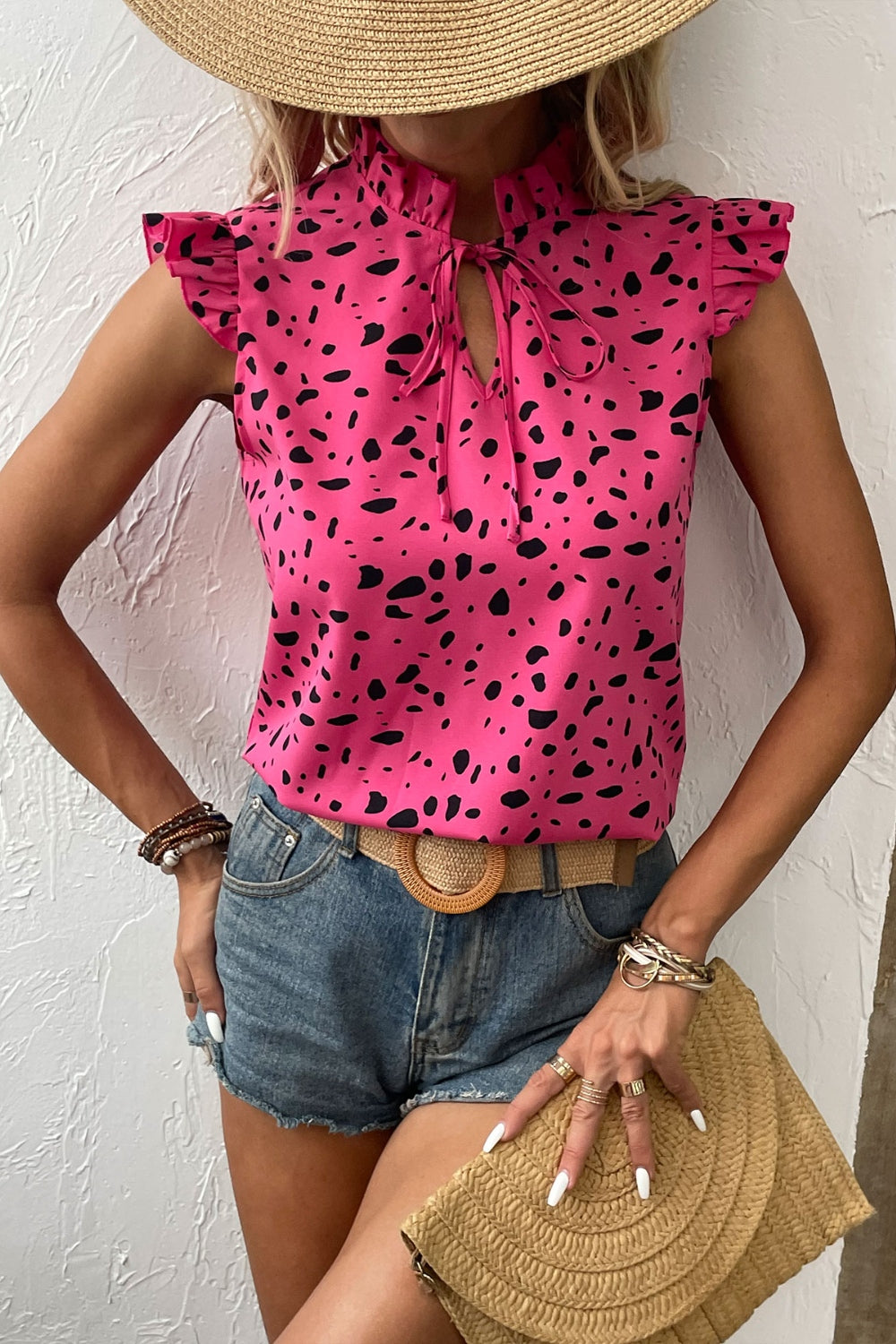 Chic fuchsia tie-neck blouse with playful prints, perfect for summer. Flattering fit, easy to style, and breezy for warm days