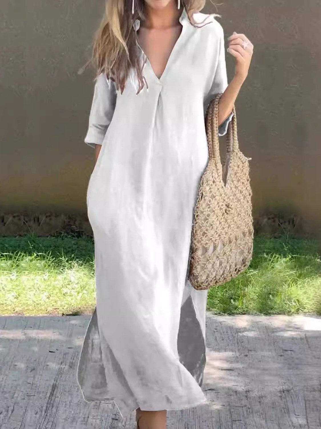 White maxi dress with a flattering V-neck and practical side pockets.