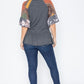 Charcoal gray top with a peplum hem and patchwork sleeves