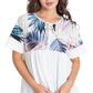 Colorful tropical leaf print top with short sleeves and tie-neck feature.