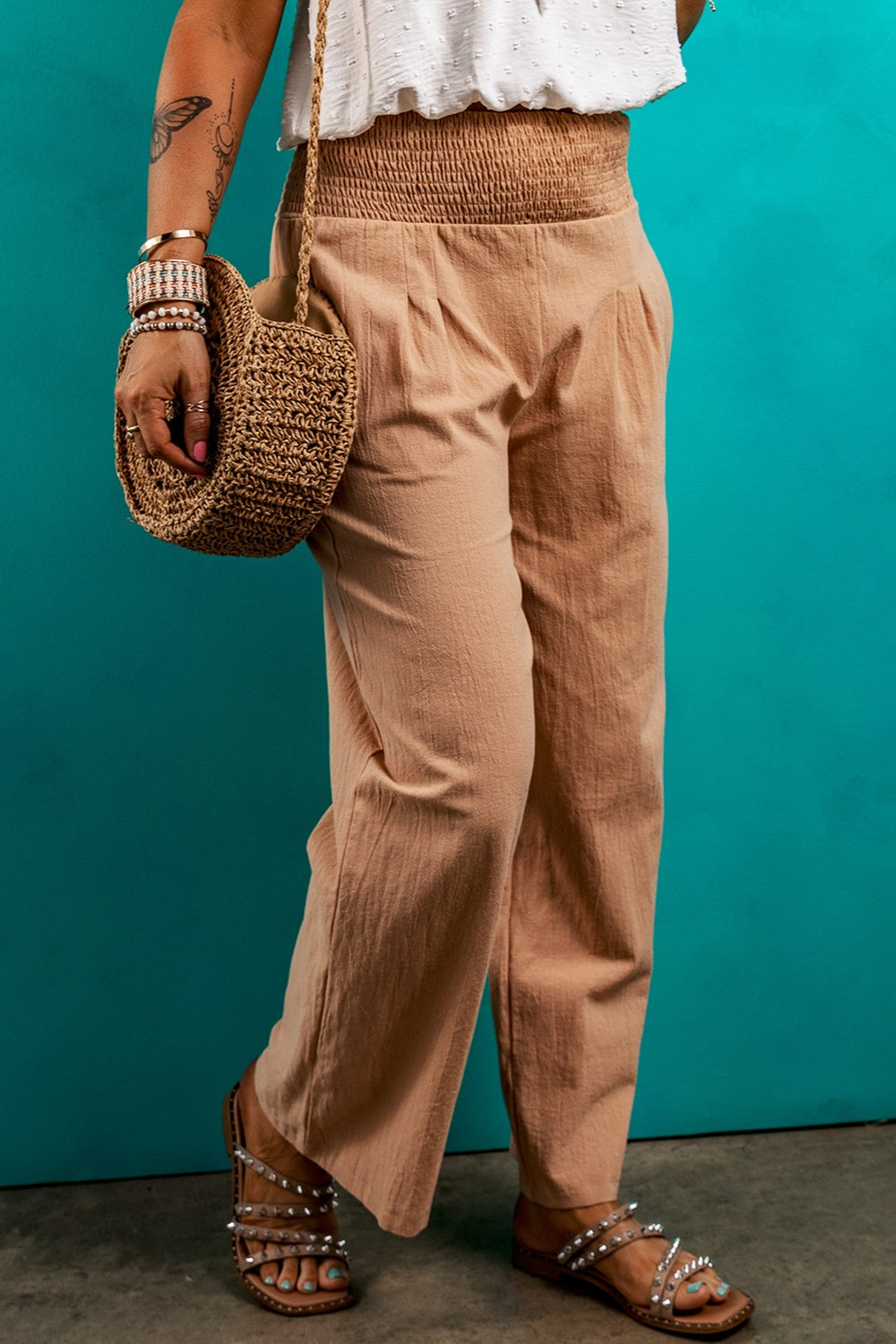 High-waisted beige drawstring pants with a relaxed fit.