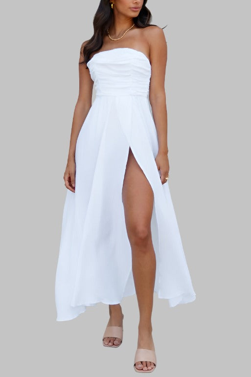 Strapless white maxi dress with ruched bodice and high slit.