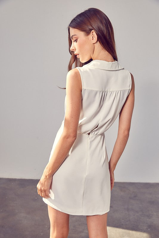 Elegant white sleeveless dress with tailored fit.