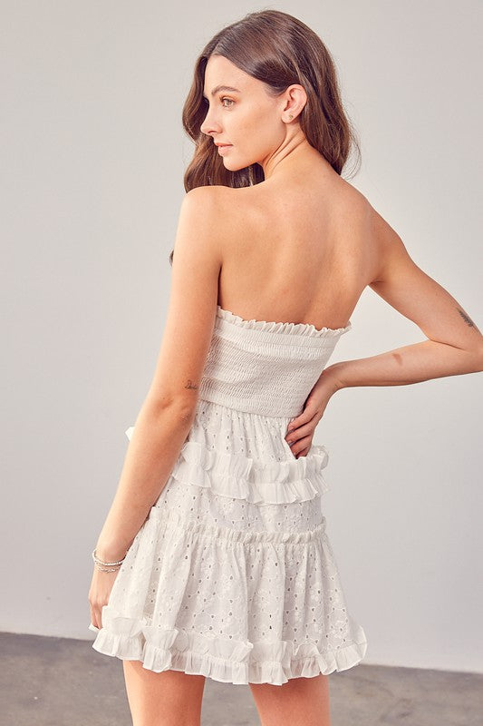 Stylish white strapless mini dress with eyelet pattern