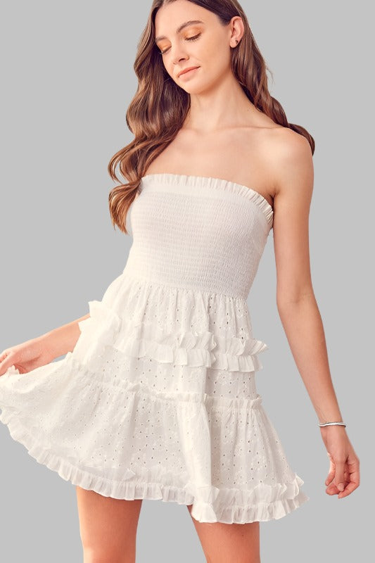 Elegant white strapless dress with ruffle and eyelet details