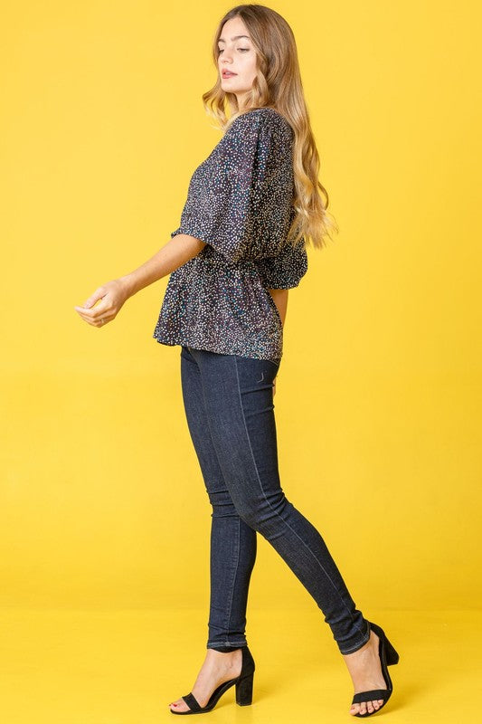 Stylish navy blouse with peplum silhouette and dots