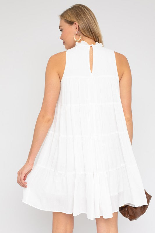 Elegant white sleeveless dress with a tiered, flowy skirt.