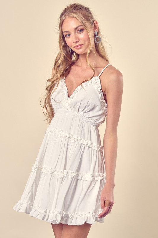 White ruffle mini dress with spaghetti straps and V-neck