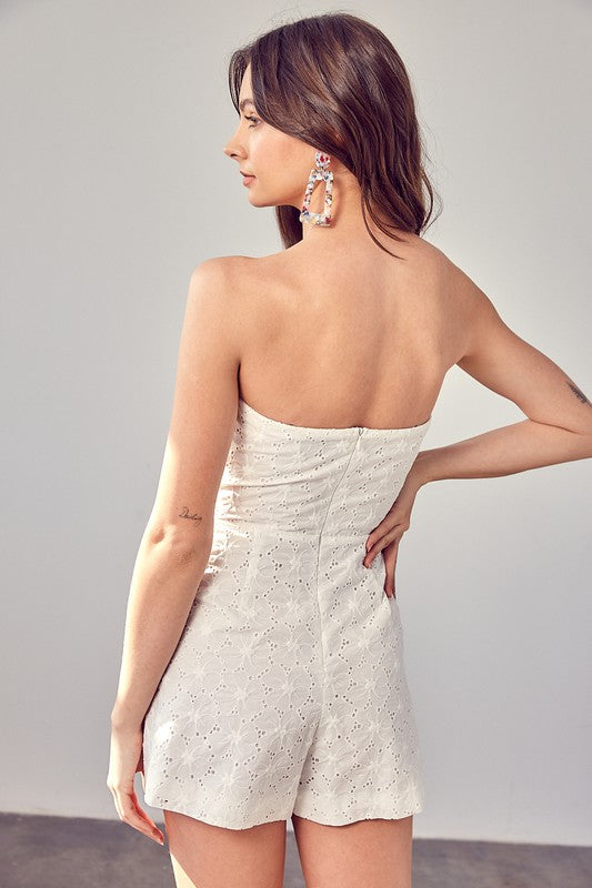 White eyelet romper with structured bodice.