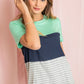 Women's tee featuring green, navy, and gray color block stripes