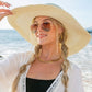 Elegant summer hat with a wide brim and bow, providing excellent UV protection.