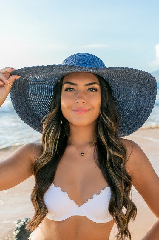 Elegant wide brim straw hat with bow detail, perfect for sun protection.