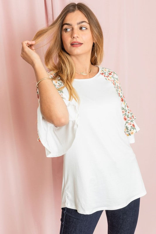 Casual plus size white top with floral ruffled sleeves.