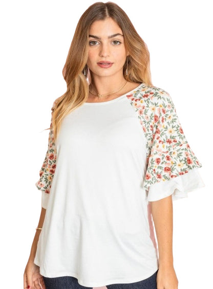 Plus size white blouse with floral ruffle details.