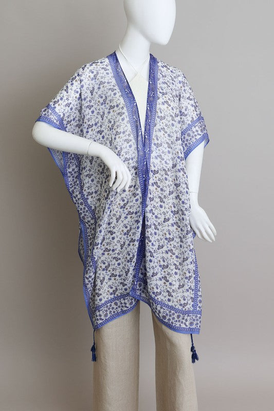Bohemian kimono with intricate blue designs and flowy fabric.