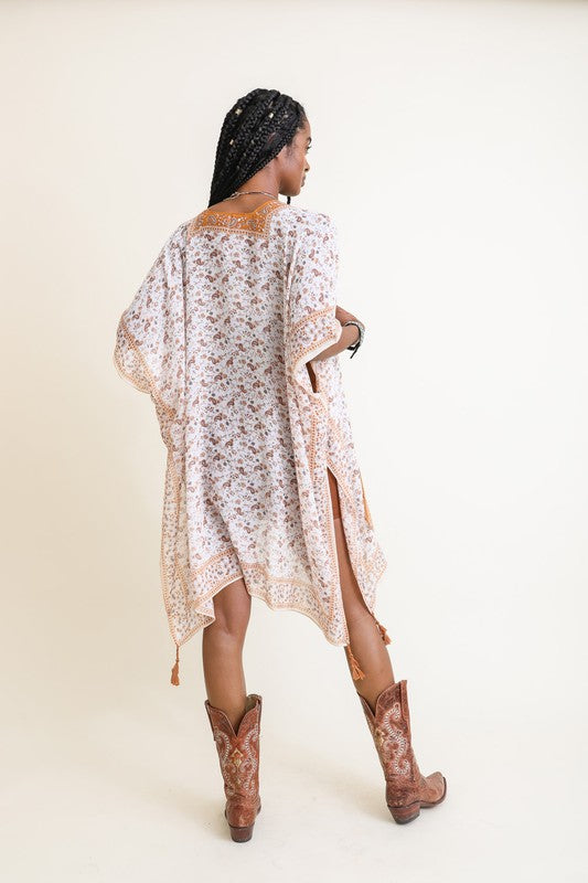 Lightweight kimono with a breezy fit and orange floral patterns.