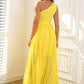 Bright yellow dress with an asymmetric neckline and a long, airy skirt