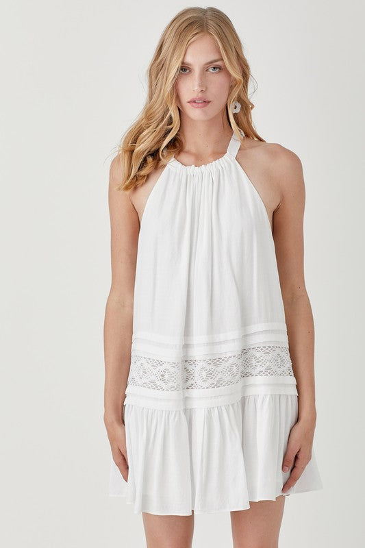 White dress with lace trim and comfortable halter design.