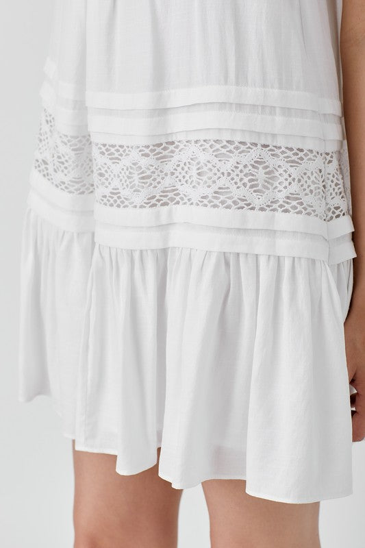 Versatile white dress featuring lace detailing and halter neck.