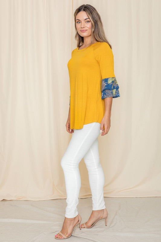 Casual yellow top with contrasting floral sleeves