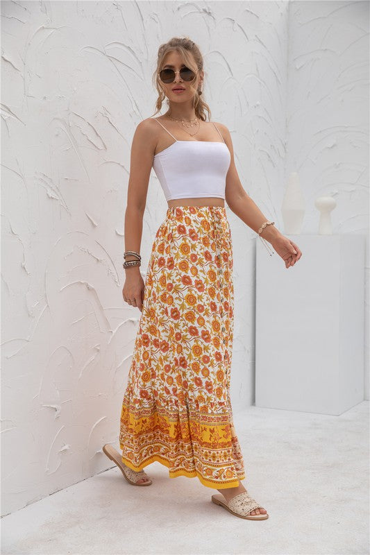 Orange boho-chic maxi skirt with floral pattern