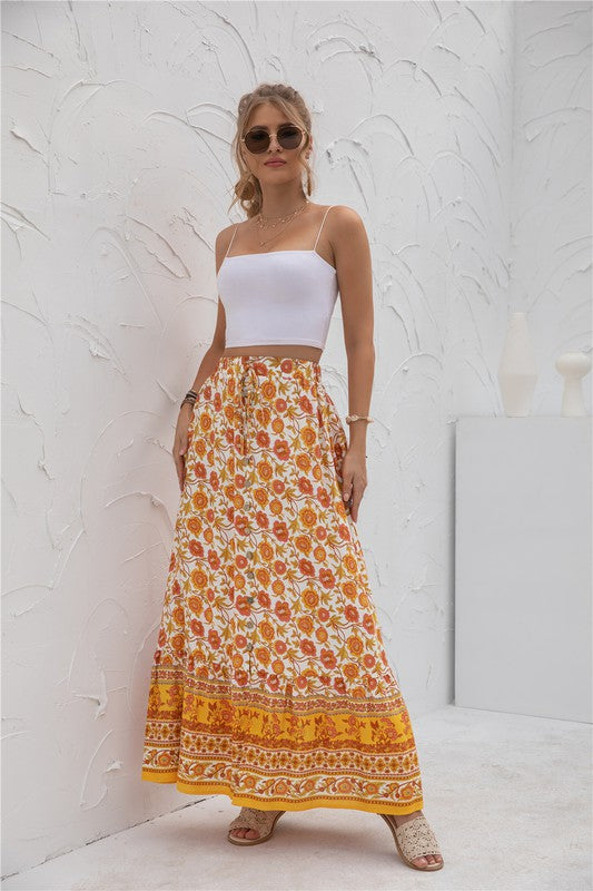 Orange floral maxi skirt featuring a relaxed, flowy design