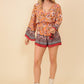 Floral print romper with bell sleeves and elastic waistband