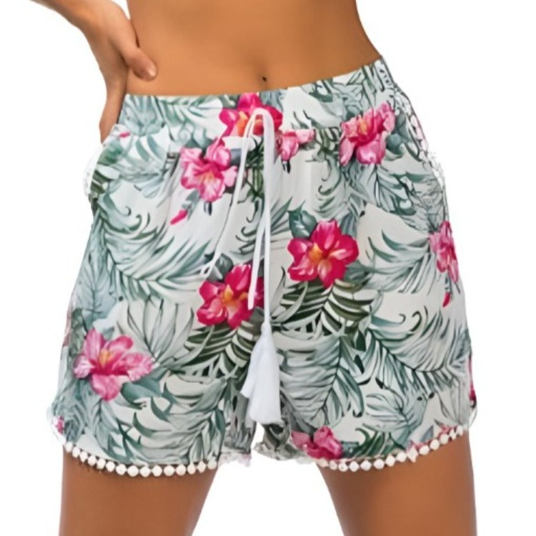 Comfortable and stylish tropical print shorts with pom pom trim for a fun summer look