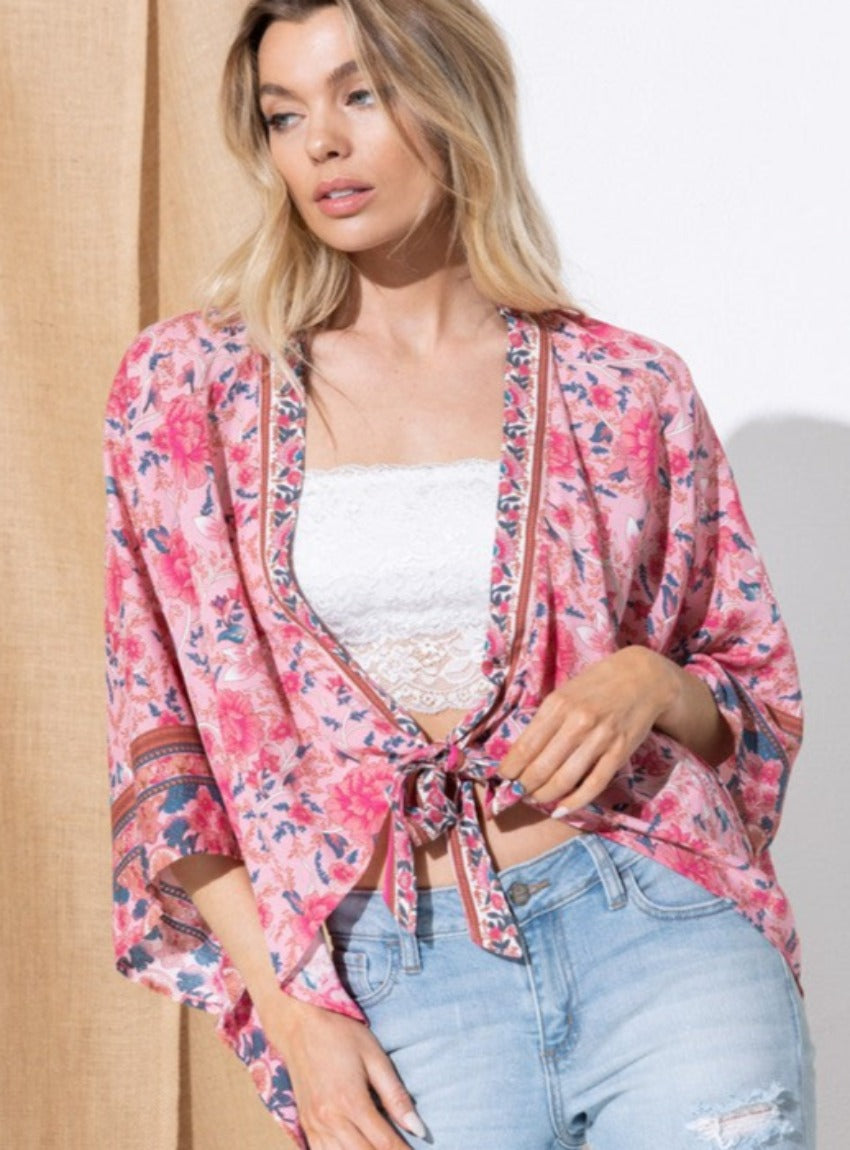 Vibrant pink floral kimono with flowy silhouette.