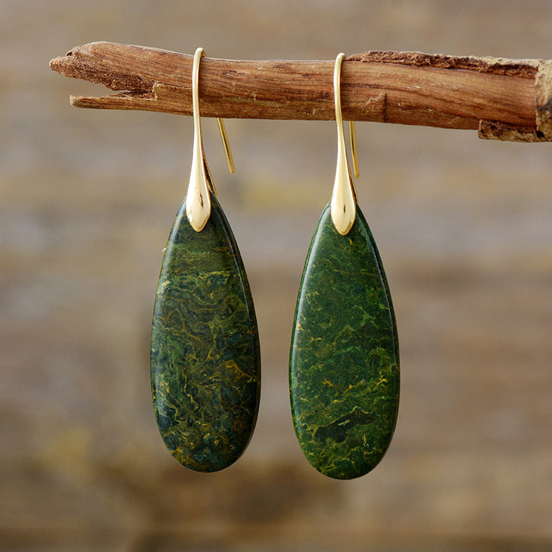 Teardrop earrings with green stone and sleek gold hooks.