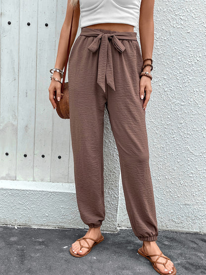 Lightweight brown drawstring pants with bohemian print.