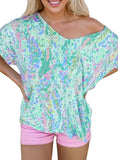 Colorful off-shoulder top with vibrant abstract print