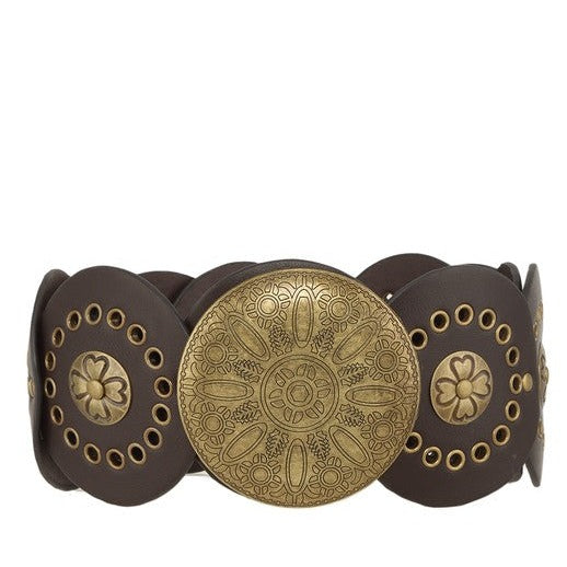Close-up of dark brown Western belt with detailed gold accents and central medallion.