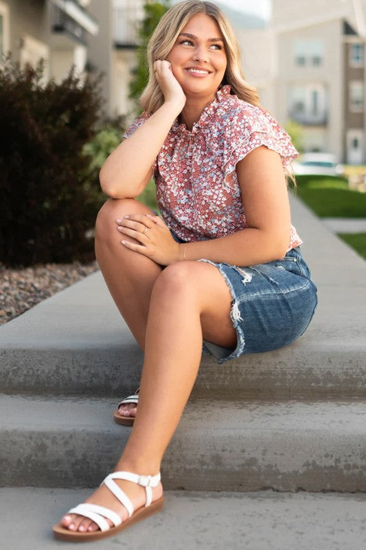 Plus size red floral top with elegant ruffle sleeve detail.