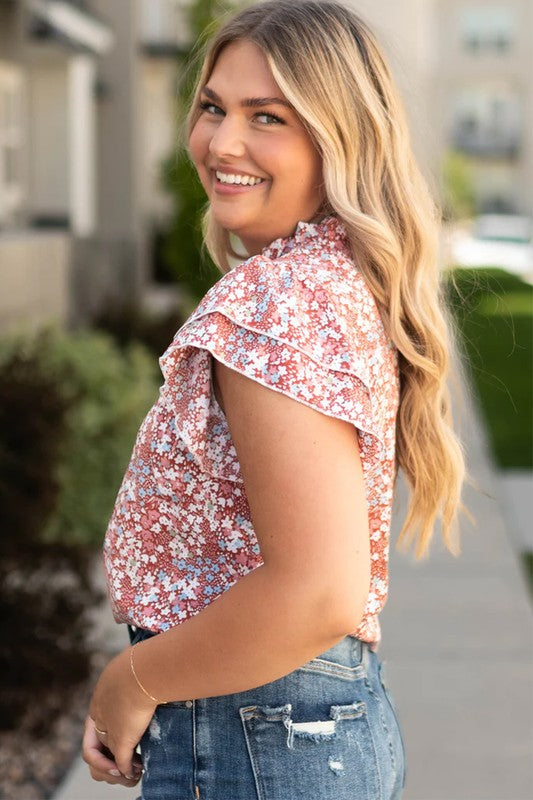 Lightweight floral blouse with playful ruffle sleeves.