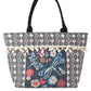 Black and white geometric tote bag with colorful beaded dragonfly design and tassel accents